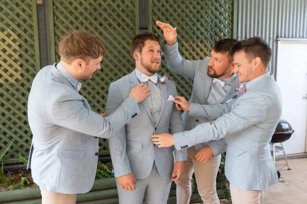 Groomsmen laughing while getting ready